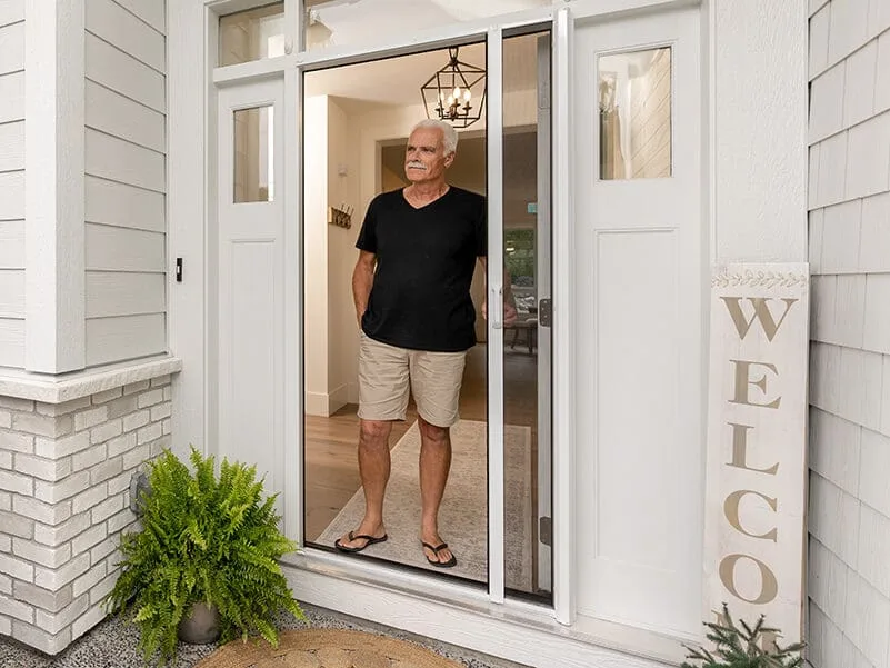 A white retractable insect screen fitted across a front doorway.